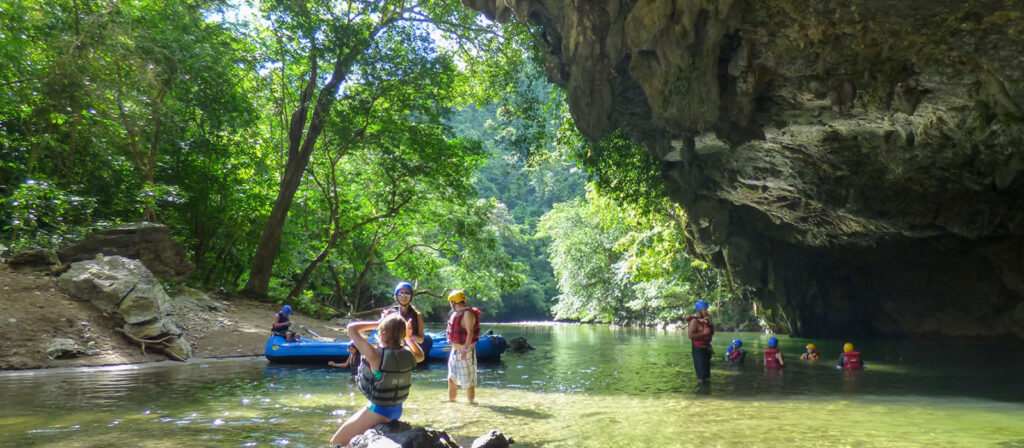 Travelers enjoying a scenic rafting trip down the turquoise waters of Río Claro.