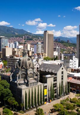 Medellin City Tour & Comuna 13 visitors exploring colorful graffiti murals and outdoor escalators with local guide.