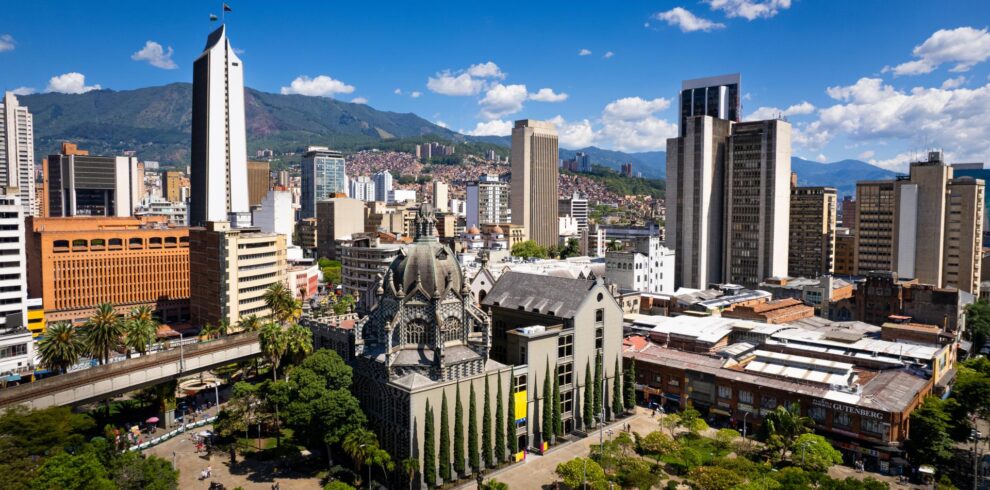 Medellin City Tour & Comuna 13 visitors exploring colorful graffiti murals and outdoor escalators with local guide.